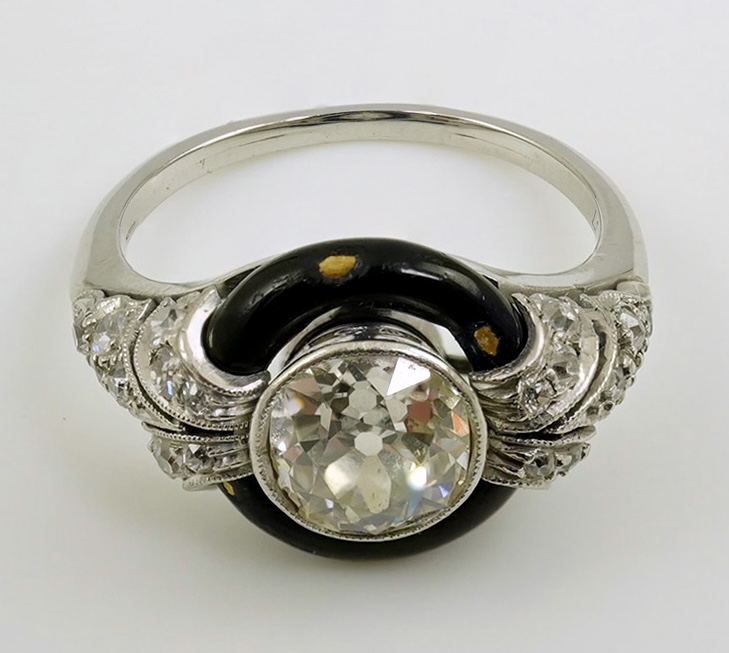 An Art Deco platinum black enamel and diamond set ring